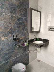a bathroom with a sink and a mirror at Luxurious 2 BHK Apartment - Home away from Home ! in Udaipur