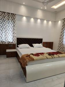 a bedroom with a large bed in a room at Luxurious 2 BHK Apartment - Home away from Home ! in Udaipur +16 photos