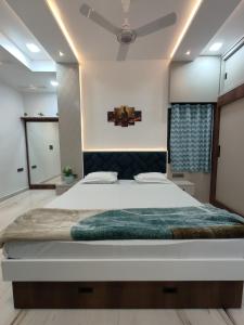 a bedroom with a large bed and a ceiling at Luxurious 2 BHK Apartment - Home away from Home ! in Udaipur