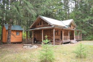 a log cabin in the woods with a house at Cascade Log Cabin | Mt Rainier, WIFI, Log Cabin in Packwood