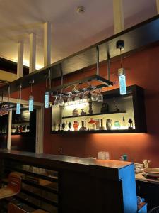 a kitchen with a bar with pots and pans at Ivy Bliss Studio with Common Pool, B 14, Karjat in Karjat