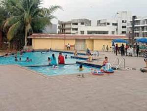 a group of people in a swimming pool at Ivy Bliss Studio with Common Pool, B 14, Karjat in Karjat