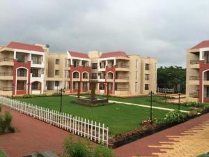 a row of apartment buildings with a white fence at Ivy Bliss Studio with Common Pool, B 14, Karjat in Karjat