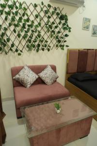 a living room with a couch and a table at Ivy Bliss Studio with Common Pool, B 14, Karjat in Karjat