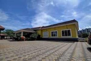 a yellow house with a large driveway in front of it at Ivy Bliss Studio with Common Pool, B 14, Karjat in Karjat