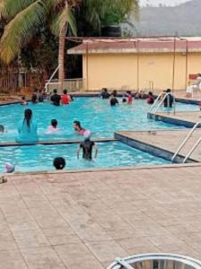a group of people in a swimming pool at Ivy Bliss Studio with Common Pool, B 14, Karjat in Karjat
