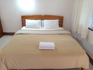 Postel nebo postele na pokoji v ubytování Phumchan Place Hotel