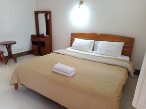 Postel nebo postele na pokoji v ubytování Phumchan Place Hotel