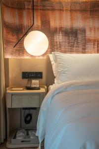 Postel nebo postele na pokoji v ubytování Tianfu Joyhub Cheer Hotel