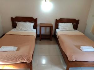 Postel nebo postele na pokoji v ubytování Phumchan Place Hotel
