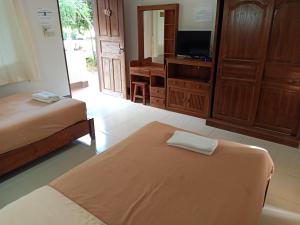 Postel nebo postele na pokoji v ubytování Phumchan Place Hotel