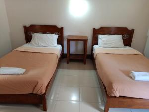 Postel nebo postele na pokoji v ubytování Phumchan Place Hotel