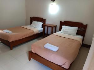 Postel nebo postele na pokoji v ubytování Phumchan Place Hotel
