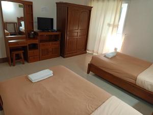 Postel nebo postele na pokoji v ubytování Phumchan Place Hotel