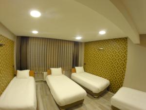 Postel nebo postele na pokoji v ubytování Okur Otel