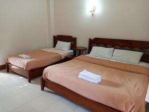 Postel nebo postele na pokoji v ubytování Phumchan Place Hotel