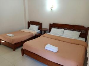 Postel nebo postele na pokoji v ubytování Phumchan Place Hotel + 37 fotografií