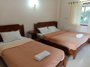 Postel nebo postele na pokoji v ubytování Phumchan Place Hotel