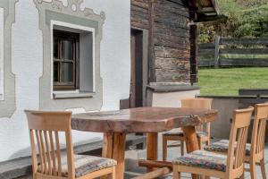 a wooden table and chairs on a patio at Peater's Hoamat in Sölden