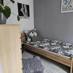 a bed in a room with a bed frame at Apartament 41 in Jelenia Góra
