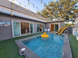 a swimming pool with a slide in a house at Wow Hua-Hin Pool Villa from beach 4km in Hua Hin