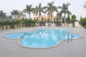 a swimming pool with a slide in a resort at The Rajgir Residency in Rājgīr