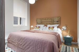 a bedroom with a large bed with white pillows at Simone by FeelFree Rentals in San Sebastián