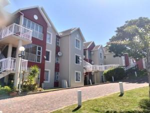 a row of houses on a brick road at 9 Dolphin Bay, Aston Bay in Jeffreys Bay