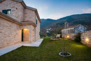 ein Steinhaus mit einem Hof mit einem Gebäude in der Unterkunft Villa Stonegate Estate - Bonus, dvije vile jedna cijena! in Opatija