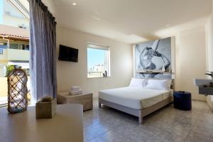 a bedroom with a bed and a large window at Prime Room in Heraklion Center in Heraklio Town