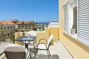 a patio with a table and chairs on a balcony at Prime Room in Heraklion Center in Heraklio Town