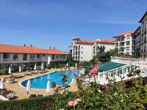 a view of a hotel with a pool and buildings at Triumph Holiday Village in Sveti Vlas
