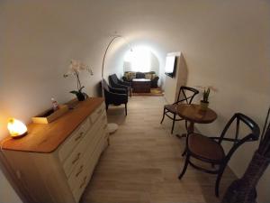 a living room with a couch and a table at Garden Cottage Zebegény in Zebegény