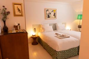 a hotel room with a bed and a night stand at Hotel du Temps Madrid in Madrid