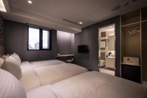 Postel nebo postele na pokoji v ubytování Yi Su Hotel-Taipei Ningxia