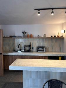 a kitchen with a counter top and a sink at Casa Tonalli in Jocotepec