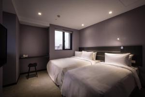Postel nebo postele na pokoji v ubytování Yi Su Hotel-Taipei Ningxia