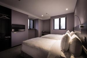 Postel nebo postele na pokoji v ubytování Yi Su Hotel-Taipei Ningxia