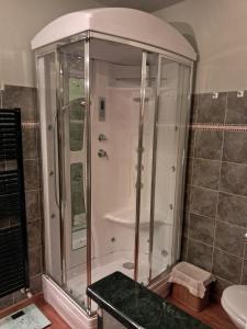 a bathroom with a shower with a glass door at Casa Dipinta in Cairo Montenotte