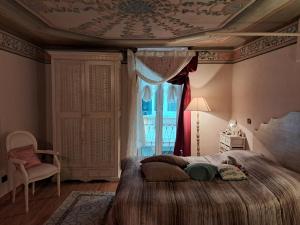 a bedroom with a large bed with a ceiling at Casa Dipinta in Cairo Montenotte