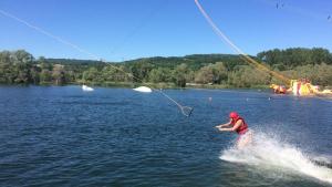 a person is water skiing on a lake at Maisonnette atypique du centre ville in Pont-à-Mousson