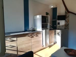 a kitchen with a sink and a counter top at Maisonnette atypique du centre ville in Pont-à-Mousson +19 photos
