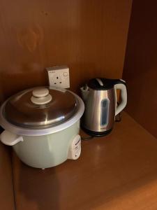 a toilet sitting on a counter next to a tea kettle at Double Storey Terrace House in Perai