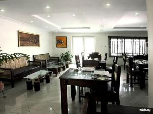 a living room filled with furniture and a table and chairs at Prince Of Anthony 1960 Hotel-apartment in Lagos