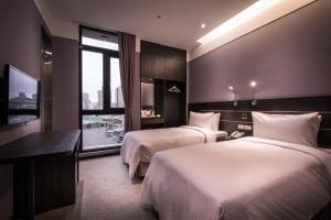 Postel nebo postele na pokoji v ubytování Yi Su Hotel-Taipei Ningxia