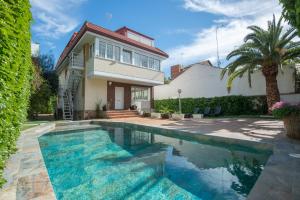 a house with a swimming pool in front of a house at Calandria Madrid in Madrid