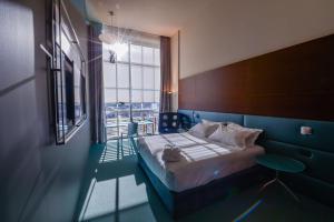 a bedroom with a bed and a large window at DoubleTree by Hilton Turin Lingotto in Turin
