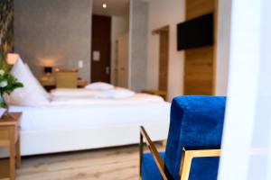 Postel nebo postele na pokoji v ubytování Hotel Gersfelder Hof