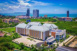 an aerial view of a building with a city in the background at Wyndham Jomtien Pattaya in Na Jomtien