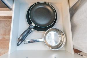 a frying pan and a mirror in a drawer at Hotel Essen mit Apartments in Essen +84 photos